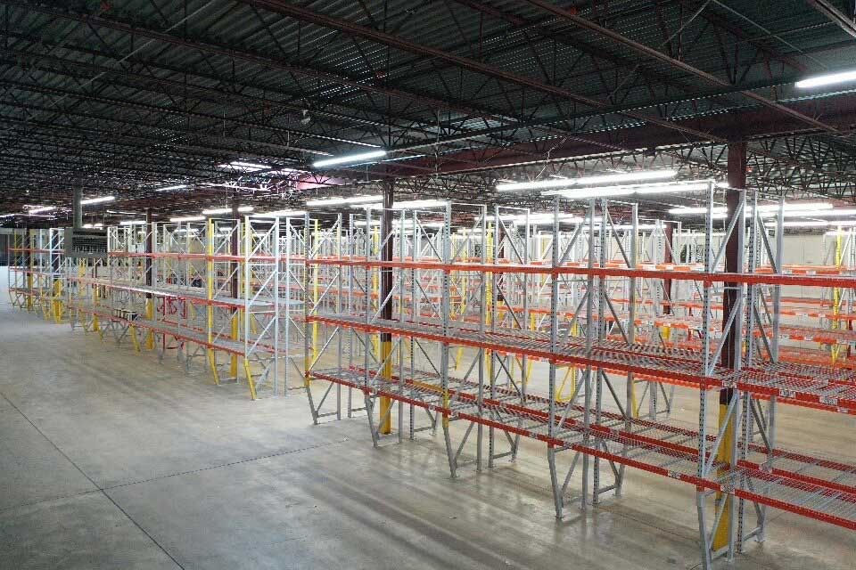 Newly installed pallet rack rows in a mid-size warehouse