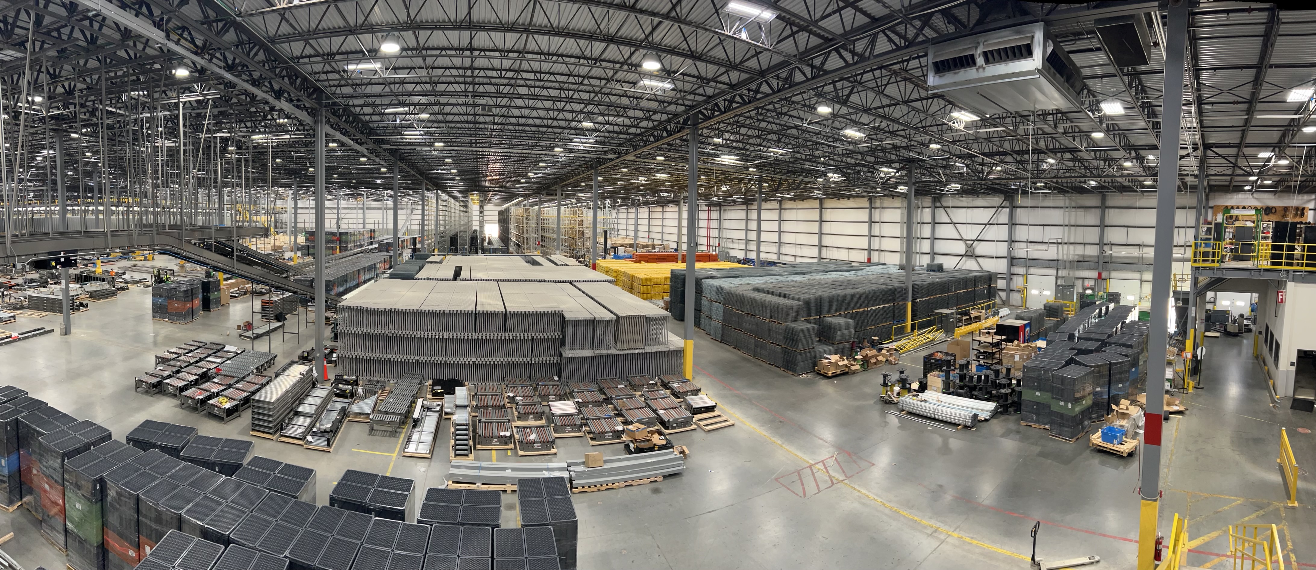Overhead view of an organized warehouse floor with clearly zoned racking and aisles