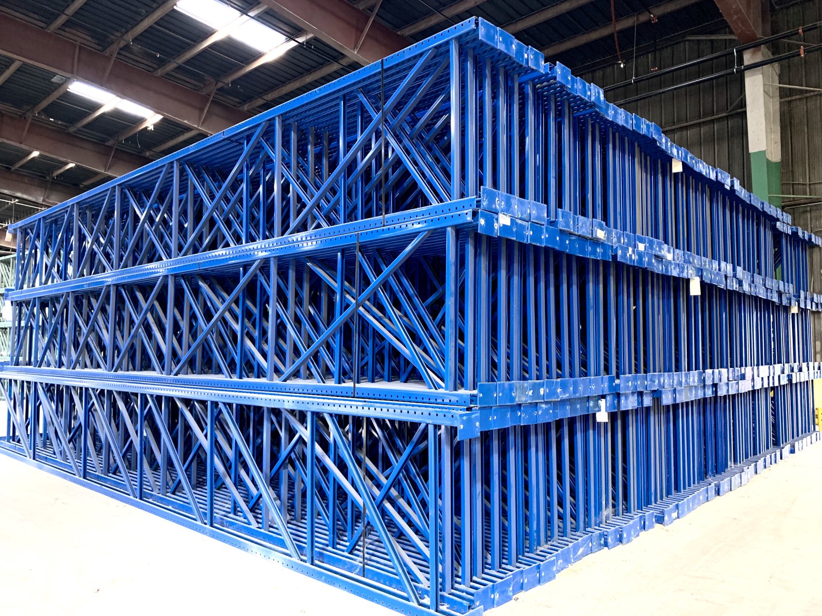 Rows of inspected, refurbished used pallet rack staged in the AMH warehouse, ready to ship