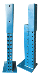Close-up view of two blue metal pallet rack shelving upright frames. Each upright frame consists of a vertical post with perforated holes for adjustable height settings and a larger, hollow rectangular piece that fits over the post for added support. Both frames have base plates for secure anchoring to the floor. The design is robust, suitable for industrial use in a warehouse or storage facility.