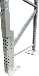 A reinforced metal rack post with a perforated design stands upright, supported by a base plate bolted to the floor. The post features an additional reinforced sleeve that wraps around the bottom portion, providing extra strength and protection against impact. Diagonal support braces are attached to the post, connecting it to another base plate, enhancing stability and rigidity. This setup indicates a repaired or reinforced shelving unit intended to bear significant loads and resist damage in a warehouse or industrial setting.